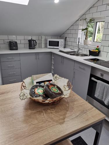 a kitchen with a basket of food on a table at Sunrise Bay - Modern Flat with stunning views in Seixal