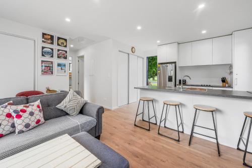 a living room with a couch and a kitchen at Lakeside Treasure - Mangakino Holiday Home in Mangakino