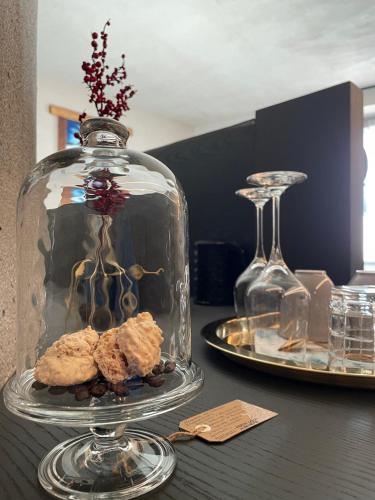 a glass cloche with cookies in it on a table at La Rêverie de Thumel - Suite in Rhêmes-Notre-Dame