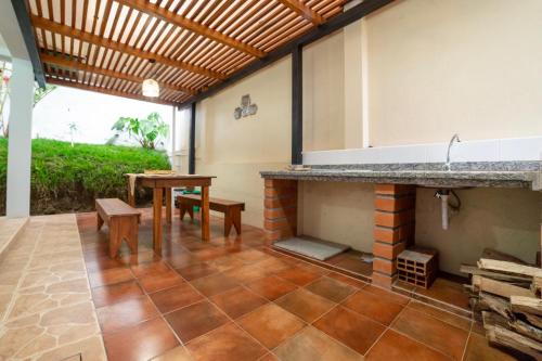 a patio with a table and a fireplace at Markinkia - Estancia Amazónica in Macas