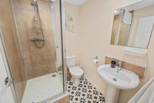 a bathroom with a shower and a toilet and a sink at Argyll Apartments - High Street, Oban in Oban