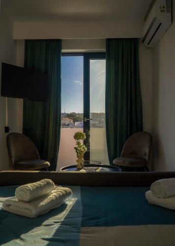 a room with a bed and a window with a view at Aegean Stars in Rhodes Town