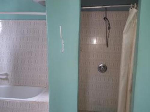 a shower in a bathroom with a tub and a sink at #11 princess apartments, 230mt to senegambia strip in Sere Kunda