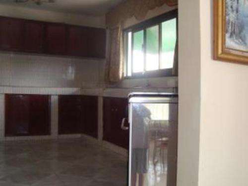 a kitchen with a refrigerator and a window in it at #11 princess apartments, 230mt to senegambia strip in Sere Kunda