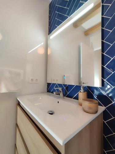 a bathroom with a sink and a mirror at El Hogarin de Veronica in Gijón