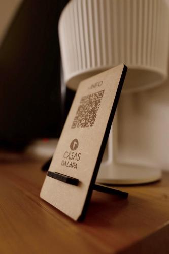 a tag on top of a wooden table at Casas Da Lapa, Nature & Spa Hotel in Seia
