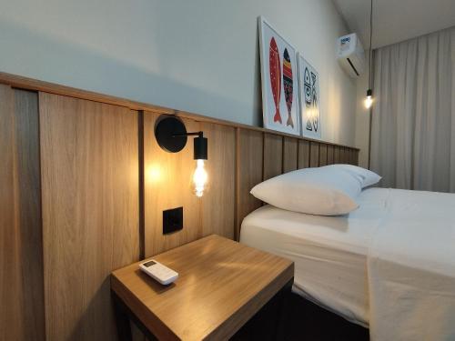 En eller flere senger på et rom på Refúgio Praiano em Bombinhas - Aluguel Temporada