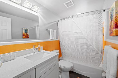 a bathroom with a sink and a toilet and a shower at Midtown Cottage - In the heart of Cocoa Beach in Cocoa Beach
