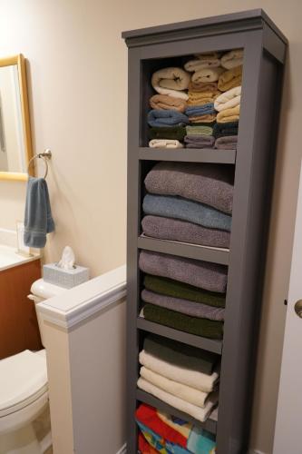 a bathroom with a rack of towels at Walkout Basement Near Creation Museum in Hebron