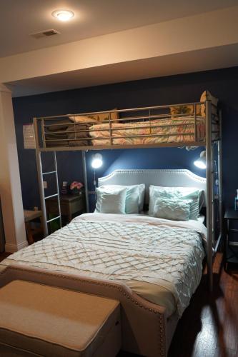a bedroom with a bunk bed with a blue wall at Walkout Basement Near Creation Museum in Hebron