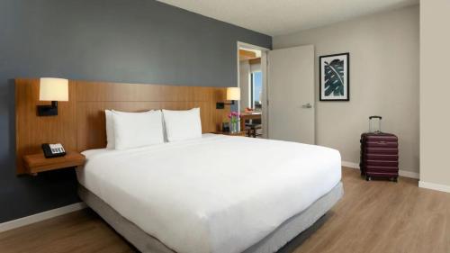 a large white bed in a hotel room at Hyatt Place San Juan in San Juan