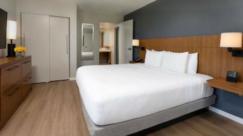a large white bed in a hotel room at Hyatt Place San Juan in San Juan