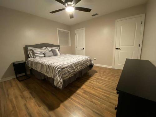 a bedroom with a bed and a ceiling fan at NEW! Luxury Home in Central McAllen in McAllen