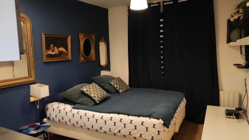 a bedroom with a bed in a room at Le Moment Bleu in Strasbourg