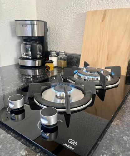 a counter top with two burners on a coffee machine at Depto. equipado, Dos Habitaciones, Zona Céntrica in Tulancingo