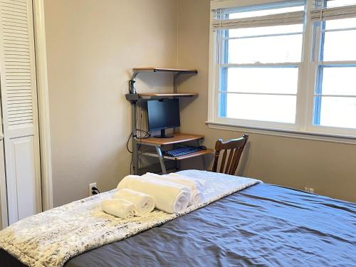 a bedroom with a bed and a desk and a window at Serene Landing Place near Downtown Cary in Cary