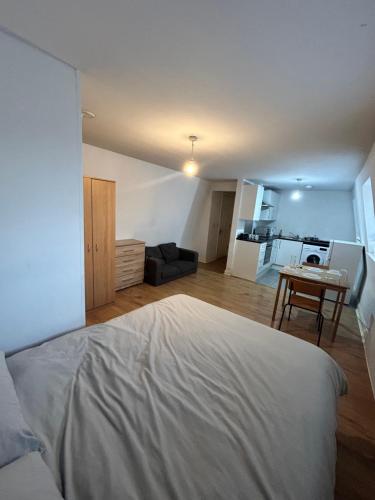 a bedroom with a bed and a living room at Leicester Studio at City Centre with free parking in Leicester