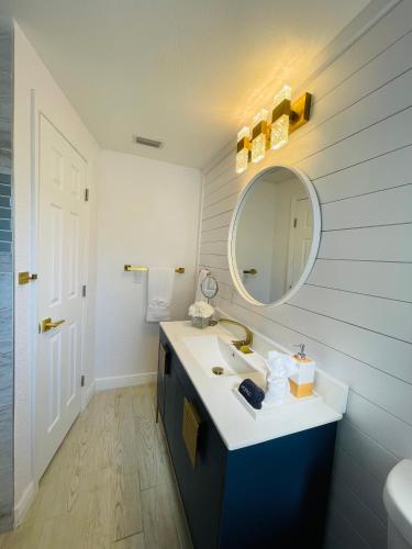 a bathroom with a sink and a mirror at Sarasota Paradise home near Siesta Key Beach in Sarasota