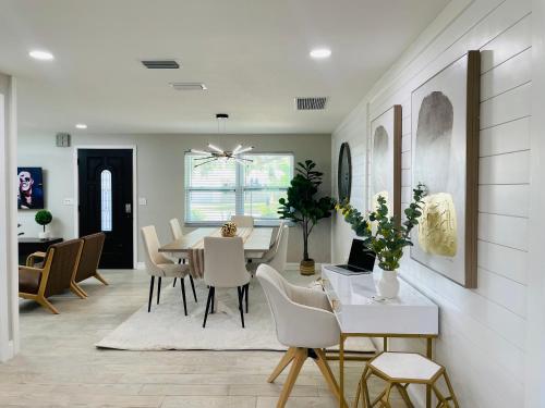 a dining room and living room with a table and chairs at Sarasota Paradise home near Siesta Key Beach in Sarasota