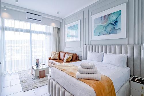 a bedroom with a large bed and a couch at Menlyn Maine Luxury Apartments 11th & 14th floor with Balcony in Pretoria