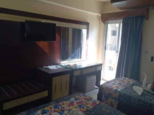 Ένα ή περισσότερα κρεβάτια σε δωμάτιο στο Windsor Hotel Luxor 中國人民飯店