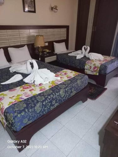 Ένα ή περισσότερα κρεβάτια σε δωμάτιο στο Windsor Hotel Luxor 中國人民飯店