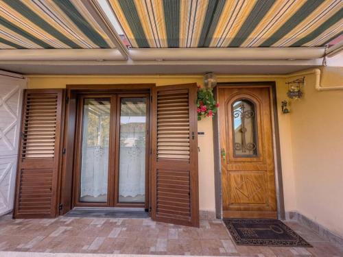 two doors on a house with a striped ceiling at [FREE PARKING] La Bianca Neve Cottage in Castel di Sangro