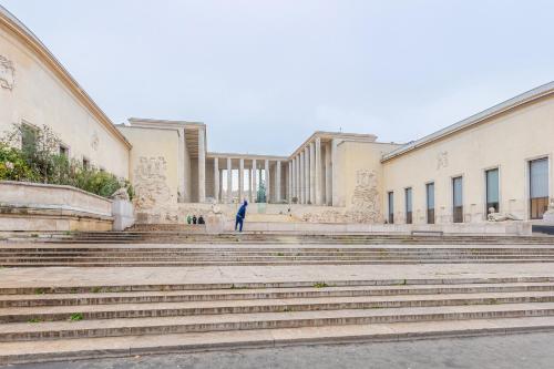 a man standing on the stairs in front of a building at Luxury Living in Trocadéro in Paris