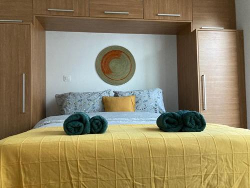 1 dormitorio con 1 cama con toallas verdes en Jade au cœur de la Marsa plage, en La Marsa