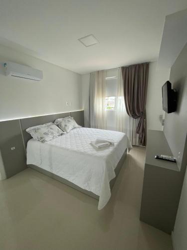 En eller flere senge i et værelse på Apartamento em Itapema Vista mar e ar
