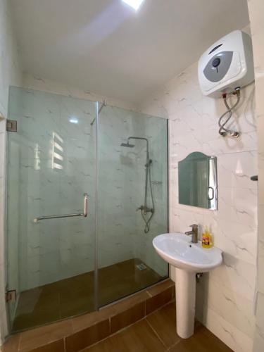 a bathroom with a glass shower and a sink at Luxury 3BR + 3.5bath apartment in Victoria Island with pool in Lagos