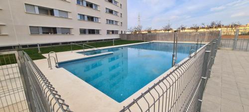 a swimming pool in front of a building at Jardines del Porvenir 4 in Puerto Real