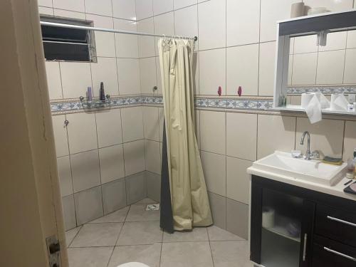 a bathroom with a shower and a sink at Lohighfive in Florianópolis