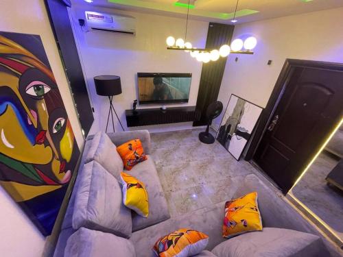 a living room with a couch with pillows at Modern 1bedroom Duplex in Port Harcourt