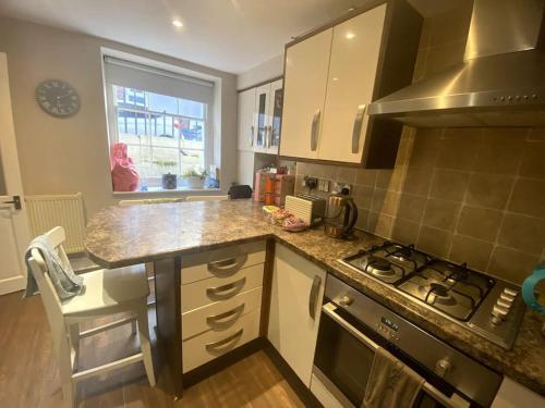 a kitchen with a stove and a counter top at Luxury Georgian Townhouse - Central Liverpool Location (Falkner St) in Liverpool