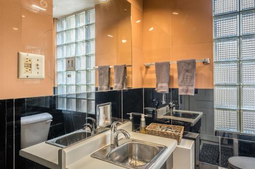 a bathroom with two sinks and a toilet at Row House Loft in Downtown Harrisburg near Hershey in Harrisburg