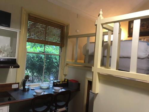 a kitchen with a bunk bed and a table and chairs at Secrets Hideaway in Blackheath