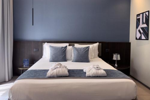 Ένα ή περισσότερα κρεβάτια σε δωμάτιο στο Hotel Vitruvio