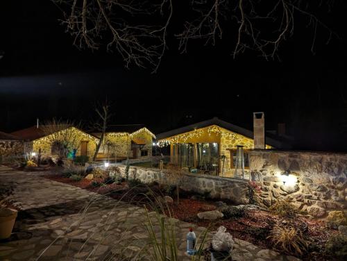 a house lit up at night with lights at Kompleks Etno Luks in Crvulevo