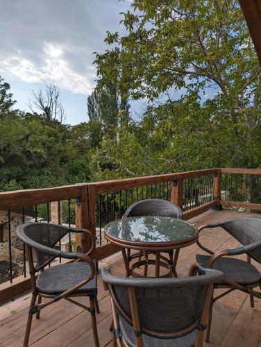 a patio with two chairs and a table on a deck at Kompleks Etno Luks in Crvulevo