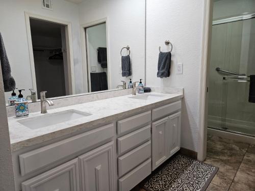 a bathroom with two sinks and a large mirror at Waterfront, Camelback Mountain, Golf Course View N in Scottsdale