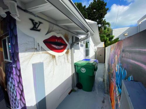 a wall with a mural of alip on it at Unique Miami Art Escape w/ HotTub, Arcade & Murals in Miami