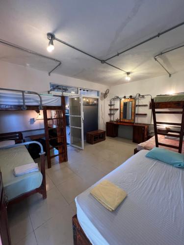 a room with two bunk beds and a bathroom at Hostel Eco Punta Cana in Punta Cana