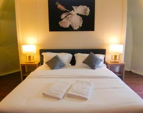 a bedroom with a bed with two towels on it at The Dome @ Gua Musang in Gua Musang