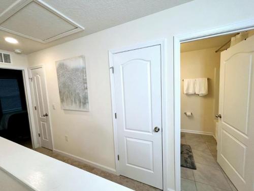 a white door in a room with a bathroom at Orange Park Townhome Vacation Rental with Patio! in Orange Park