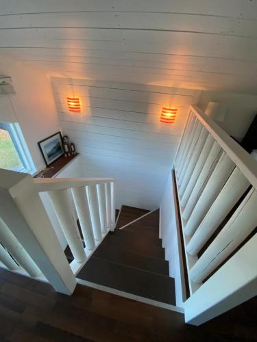 a staircase in a house with lights on the wall at Woodhouse Cottages And Ranch in Prince George