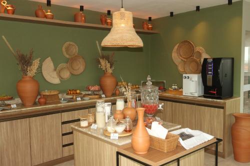 a kitchen with bowls and vases on a counter at Belaris Hotel in São Luís