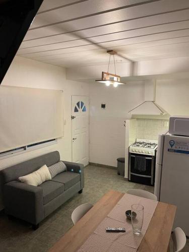 a living room with a couch and a table at Depto funcional en Comodoro! in Comodoro Rivadavia