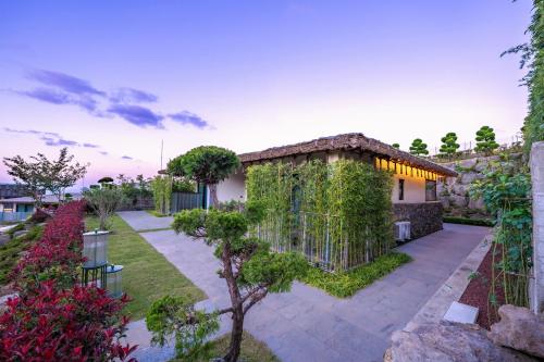 a house with ivy on the side of it at Amber Pure Hill Hotels & Resorts Jeju in Jeju