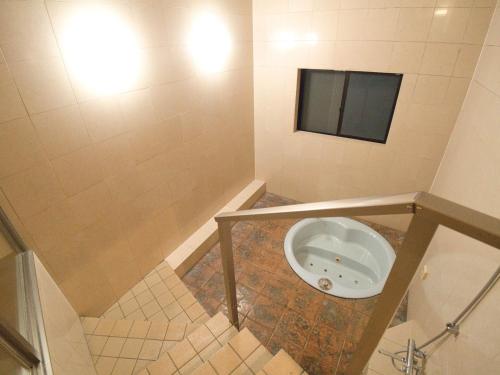 a small bathroom with a urinal in the floor at SKY Ocean-terace Omura in Omura